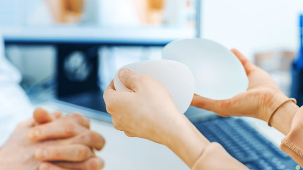 Patient holding sample breast implants