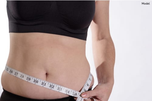 Diet and dieting. Beauty slim female body use tape measure