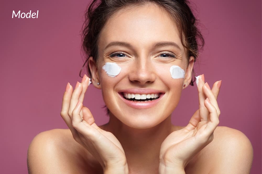 A woman exfoliating her skin to avoid facial redness