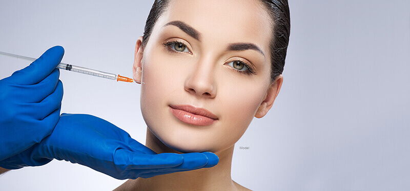 Young woman getting a cheek injection