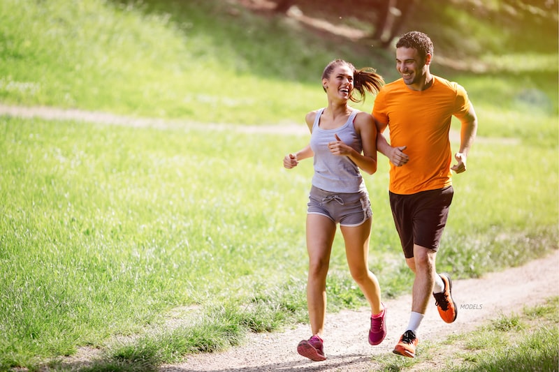 Young couple jogging in a park.